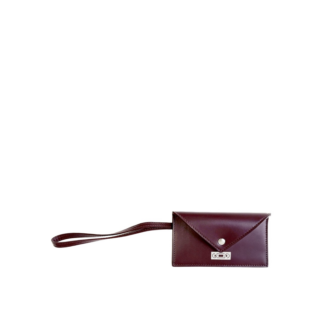 Front view of The Businesscard Holder in Bordeaux leather featuring structured envelope construction, wrist strap, and understated contemporary elegance crafted in Italy.