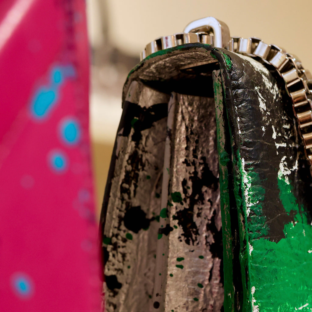 Side detail of The Cristiana “Piece of My Heart” highlighting hand-painted Piñatex, sculptural construction, palladium-plated chain hardware, and artistic dialogue within the Arte-à-Porter capsule.