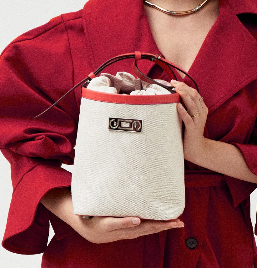 Editorial portrait of a model carrying The Francesca canvas bucket bag, expressing contemporary movement, relaxed elegance, and refined Italian craftsmanship.