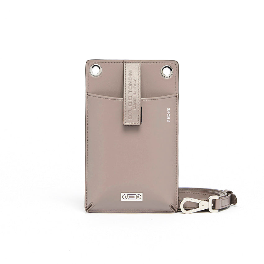 The Come Fly With Me! in Light Grey. Front view showing smooth Italian leather, compact crossbody silhouette with external phone pocket and sturdy brass hardware plated in palladium.
