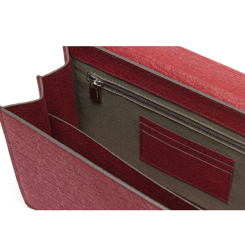 The Cristiana Vegan Shoulder Bag by Studio Tondini. Interior view of the cherry red version, revealing structured compartments lined in cotton and Piñatex® - refined, functional, and consciously crafted.