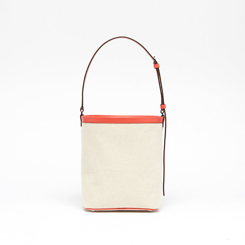 Back view of The Francesca Canvas Bucket Bag. Natural canvas and coral leather with softly structured silhouette.