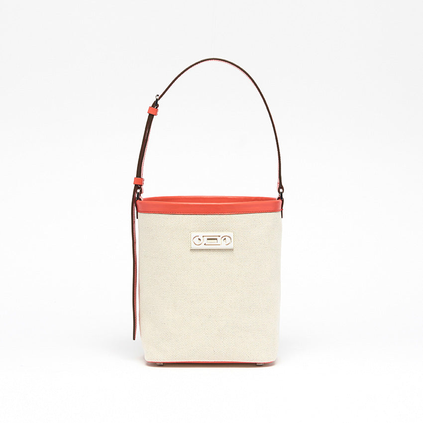 The Francesca Canvas Bucket Bag. Front view, natural canvas with coral calf leather detailing.