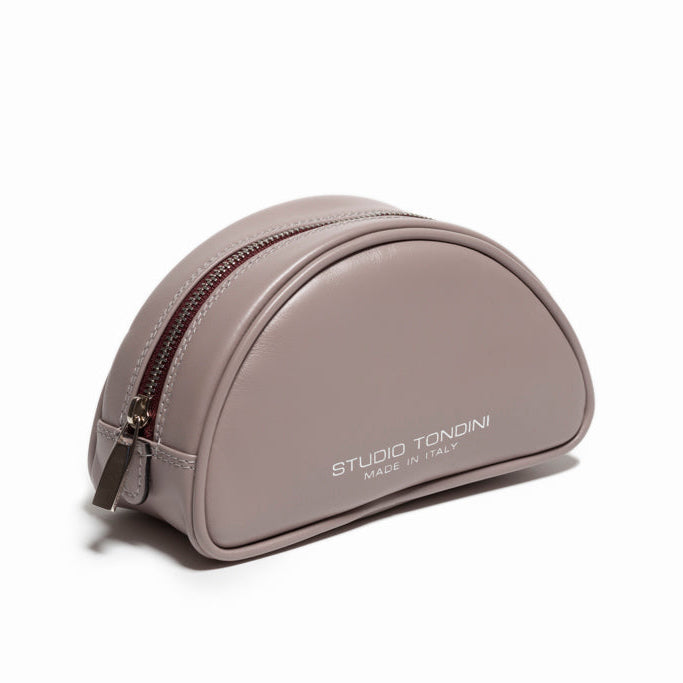 The Valentina Toiletry by Studio Tondini. Three-quarter view of light grey Italian leather pouch, featuring the signature burgundy zip detail unique to the Valentina line.