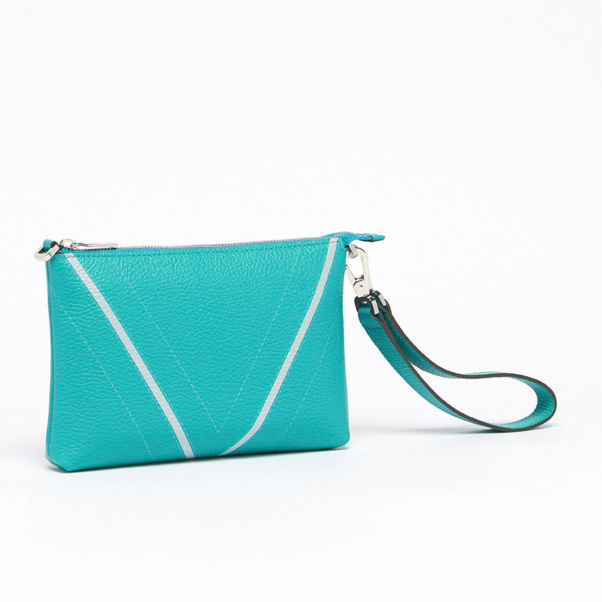 Three-quarter view of The Arianna Monochrome Pouch in Emerald grained leather highlighting sculptural proportions, versatile wearability, and understated contemporary elegance.