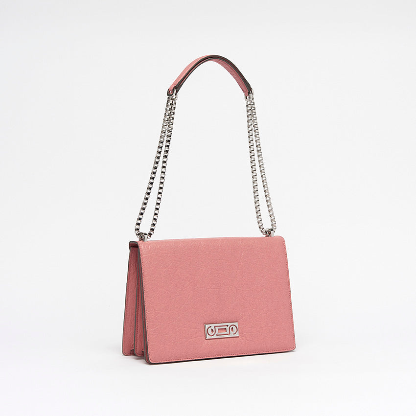Three-quarter view of The Cristiana Vegan Shoulder Bag in pink Piñatex highlighting composed structure and polished hardware.