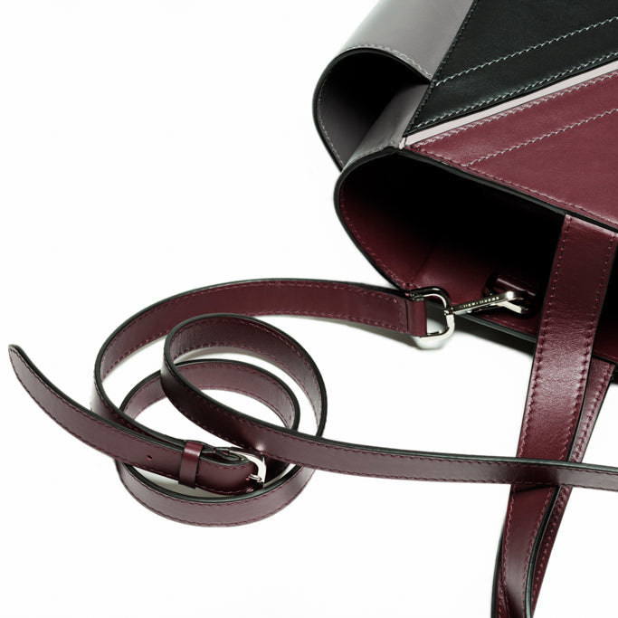 Detail view of The Long Strap by Studio Tondini in Bordeaux leather with adjustable construction, refined edge painting, and polished palladium-plated hardware crafted in Italy.