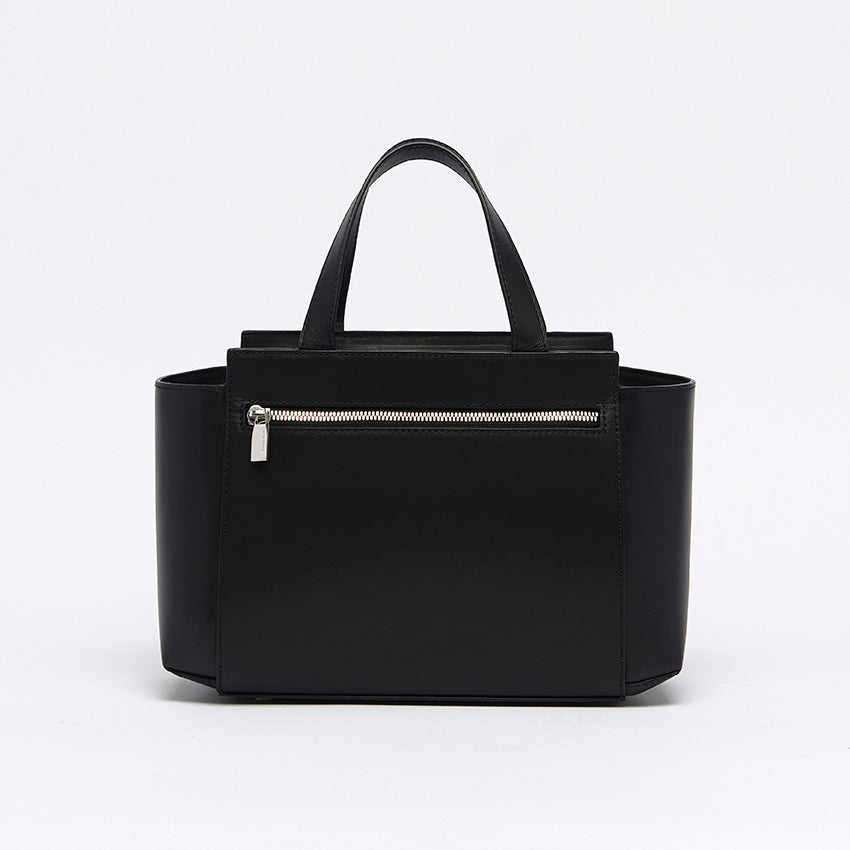 Back view of The Maja Little Tote Bag in black leather with clean architectural lines and understated sophistication.