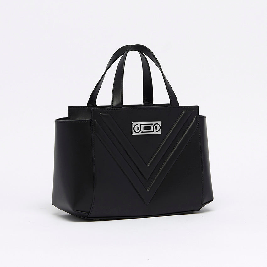 Three-quarter view of The Maja Little Tote Bag in black Italian leather featuring balanced proportions, refined structure, and elegant top handles.