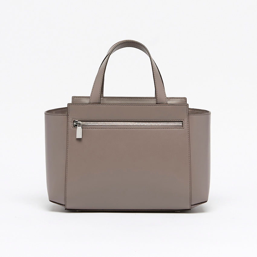 Back view of The Maja Little Tote Bag in Light Grey leather featuring minimalist lines and understated luxury craftsmanship made in Italy.
