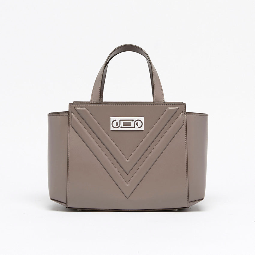 Front view of The Maja Little Tote Bag in Light Grey leather with signature V-shaped construction and structured architectural silhouette.