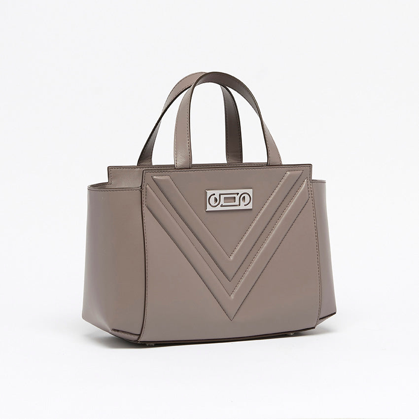 Three-quarter view of The Maja Little Tote Bag in Light Grey Italian leather with composed proportions and refined edge-painted detailing.