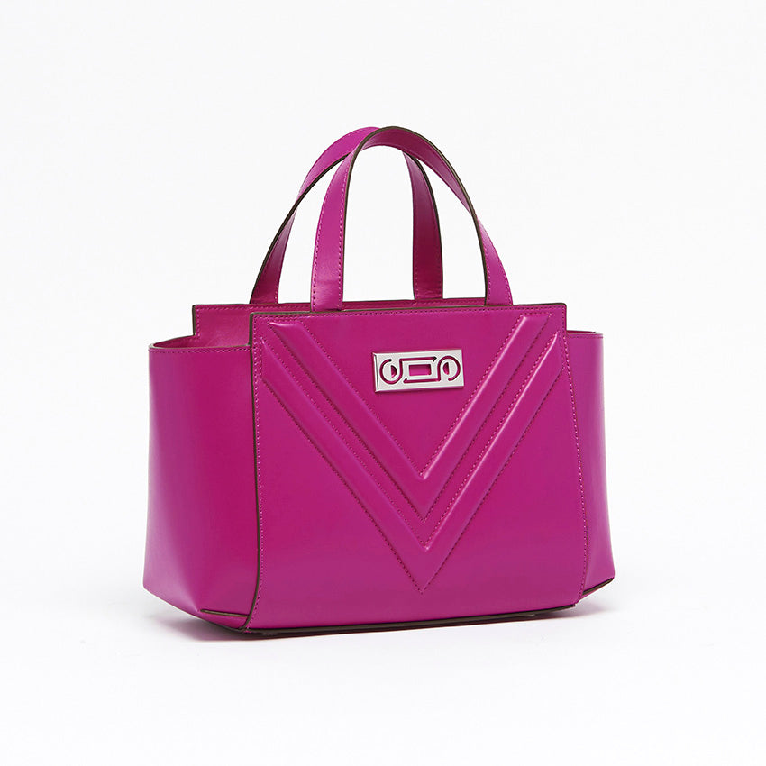 Three-quarter view of The Maja Little Tote Bag in Orchid Italian leather with sculptural proportions, top handles, and refined edge-painted construction.