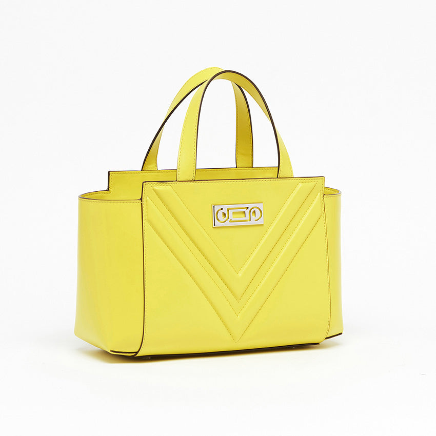 Three-quarter view of The Maja Little Tote Bag in Yellow Lime Italian leather with refined construction, balanced proportions, and elegant top-handle structure.