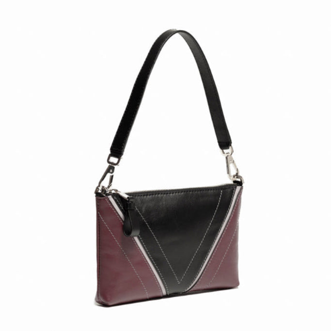 Three-quarter front view of The Arianna Pouch with Studio Tondini’s signature V-shape construction creating a black leather triangle, showcasing sculptural proportions and refined craftsmanship.