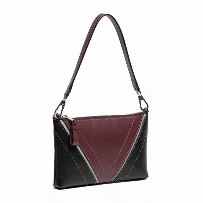 Three-quarter front view of The Arianna Pouch with Studio Tondini’s signature V-shape construction creating a bordeaux leather triangle, showcasing sculptural proportions and refined craftsmanship.