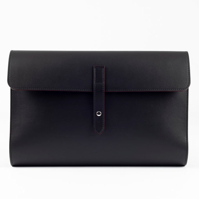 Front view of The Document Holder in smooth black leather with bordeaux edge detailing, featuring minimalist construction and refined contemporary design.