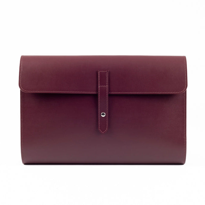 Front view of The Document Holder in smooth bordeaux leather, featuring minimalist construction and refined contemporary design.