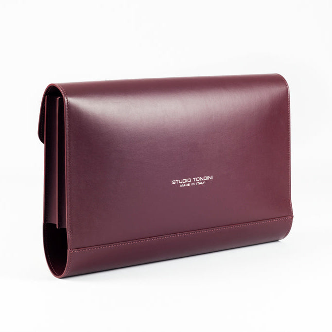 Three-quarter view of The Document Holder in smooth bordeaux leather, showcasing slim construction and understated elegance.
