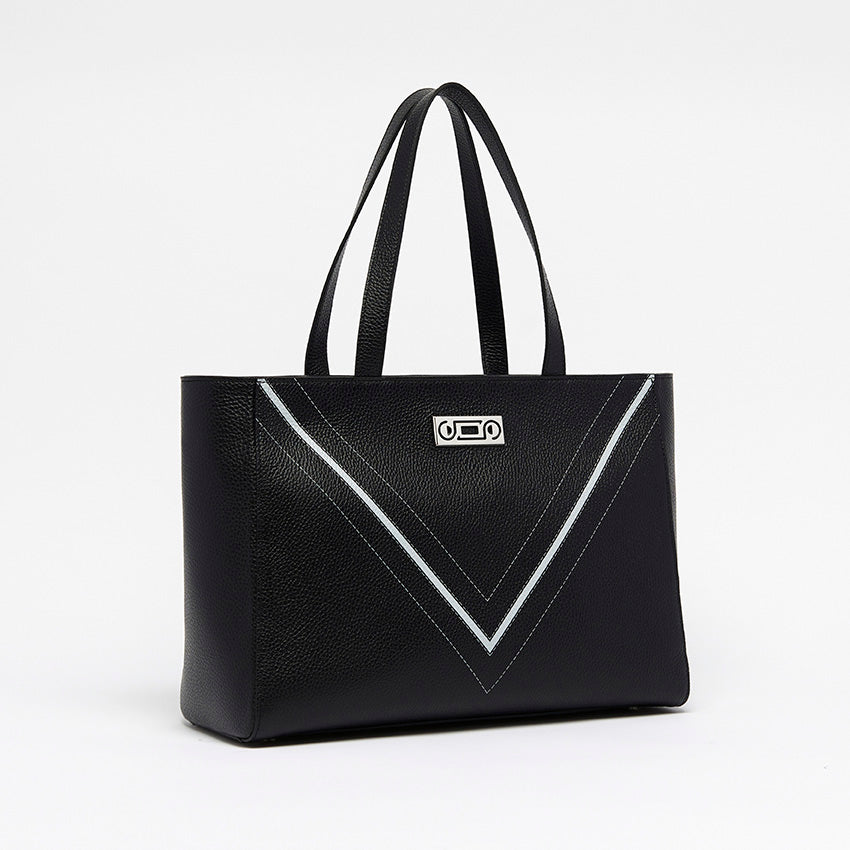 Three-quarter view of The Maja Monochrome Tote Bag in black pebbled leather, showcasing sculptural construction and contemporary Italian craftsmanship.