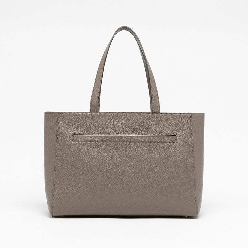Back view of The Maja Monochrome Tote Bag in taupe pebbled leather with clean architectural lines and minimalist construction.