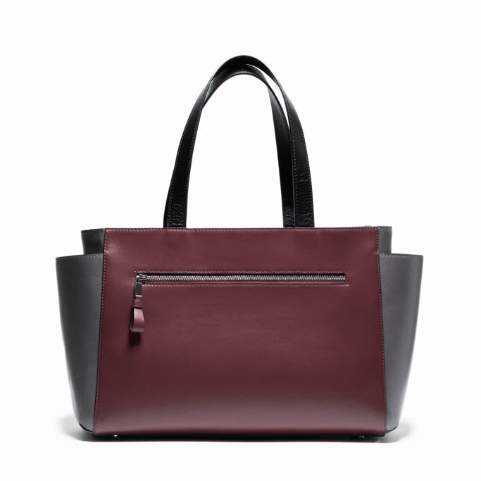 Back view of The Maja Tote Bag in smooth bordeaux leather with clean structural lines and minimalist contemporary design.