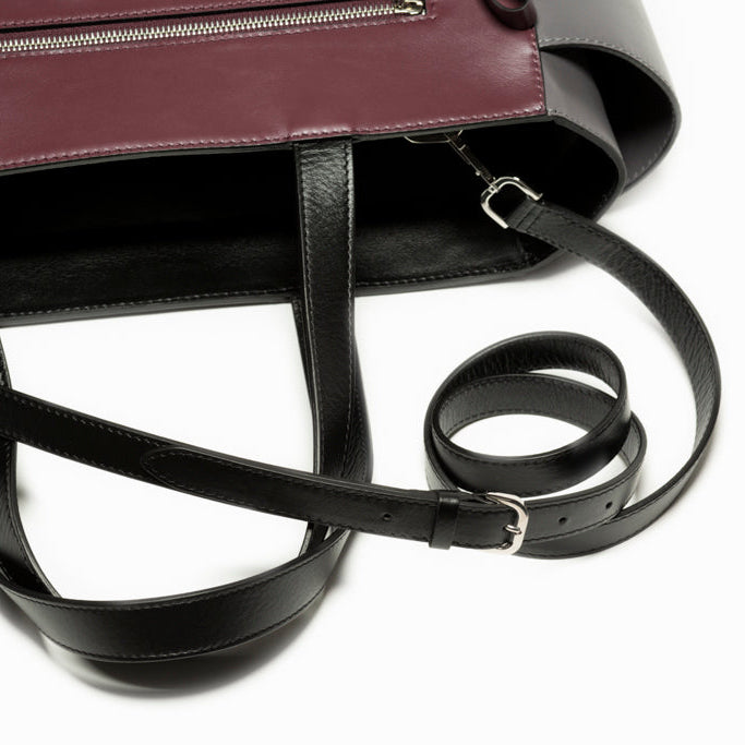 Close-up detail of The Maja Tote Bag handles and shoulder strap attachment, highlighting refined leather construction and precision craftsmanship.