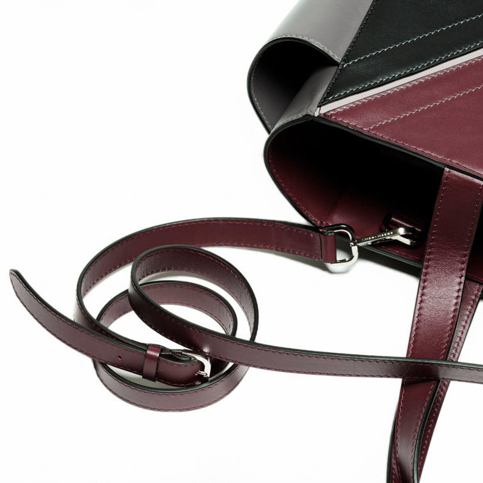 Close-up detail of The Maja Tote Bag handles and shoulder strap attachment, highlighting refined leather construction and precision craftsmanship.