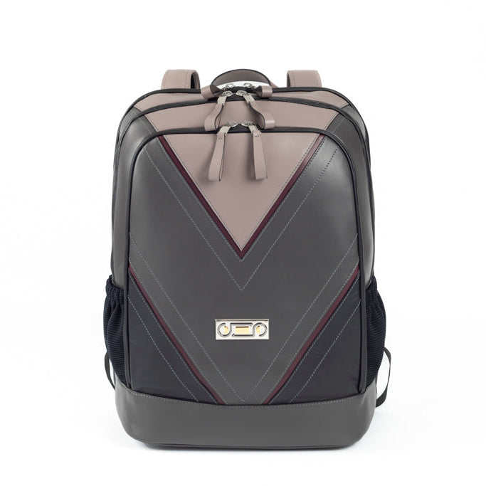 Front view of The Simona Backpack featuring Studio Tondini’s signature V-shape construction, creating a light grey leather triangle on smooth dark grey leather.