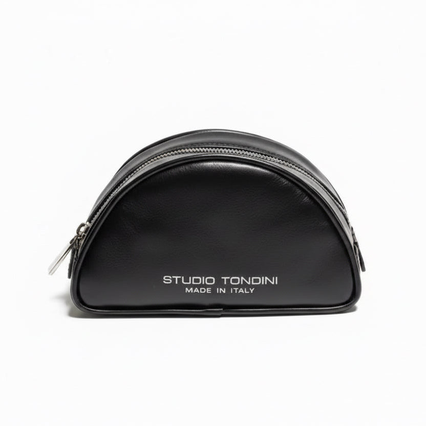 Front view of The Valentina Toiletry by Studio Tondini in black leather with compact curved structure, refined minimalist construction, and contemporary Italian craftsmanship.